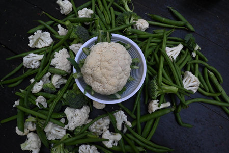 Healthy vegetables on wooden background. Food includes broccoli, cauliflower, peas and green beans.の写真素材