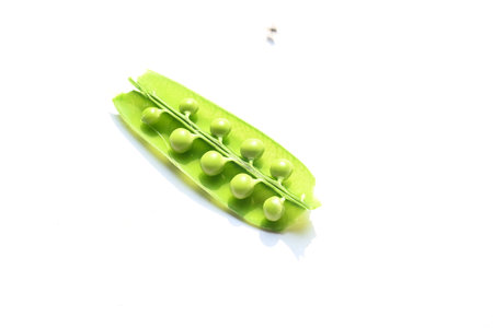 Green pea on white background. There is a lot of vitamins  and Minerals in it. TheÂ peaÂ is most...