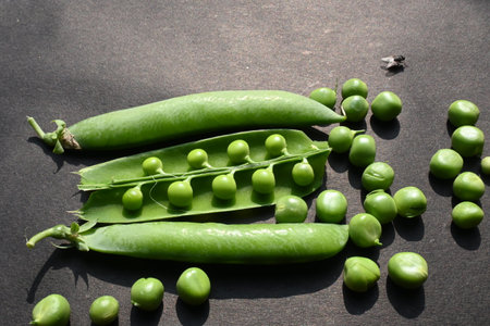 Fresh green pea on black background. There is a lot of vitamins  and Minerals in it. TheÂ peaÂ is most commonly the small sphericalÂ seedÂ or the seed.の写真素材