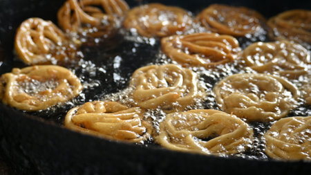 Jalebi making. It is a popular sweet snack in India subcontinent. It is many...