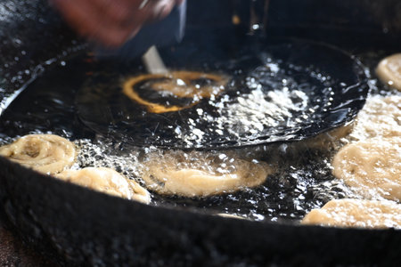 Jalebi making. It is a popular sweet snack in India subcontinent. It is many namesÂ jilapi,Â jilebi,Â jilipi,Â zulbia,Â mushabak,Â zâlabia andÂ zalabia.の写真素材