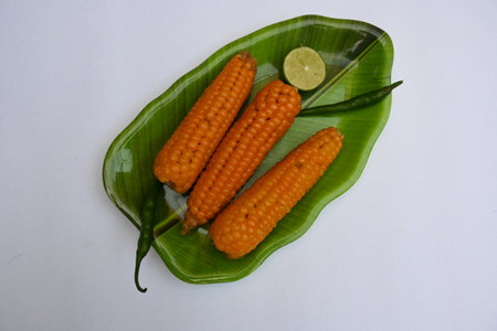 Boiled sweet corn on the plate. It contains many vitamins, such as Vitamin B1, B5, C, B9, E, A.の写真素材