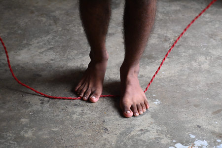 A man is standing with a rope. Jumping rope, also known as skipping, is a highly effective and...