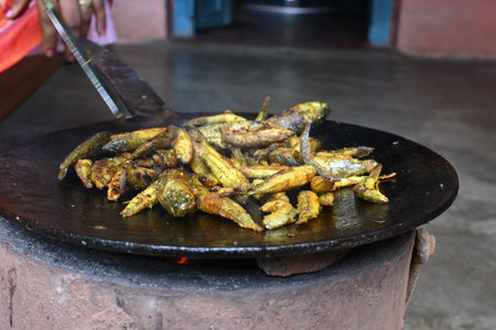 Small Snakehead or Channa orientalis Fish being fried in a pan. Its typically marinated with spices like turmeric, salt, and chili powder before being fried until they are crispy.の写真素材