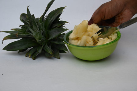 Pineapple or Ananas comosus slices on white background. It is aÂ tropical plantÂ with an edible...