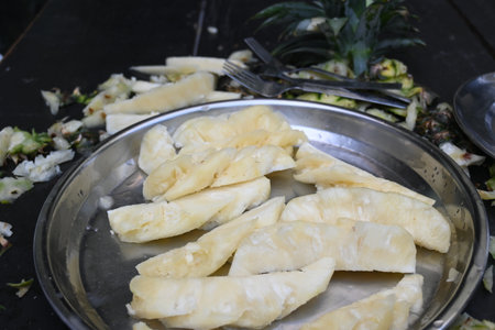 Pineapple or Ananas comosus chopping with knife. It is aÂ tropical plantÂ with an edible fruit. It is plant in the familyÂ Bromeliaceae. Fruits cutting.の写真素材