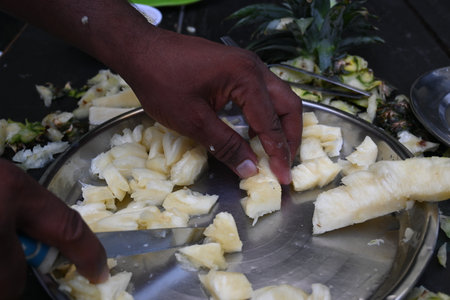 Pineapple or Ananas comosus chopping with knife. It is aÂ tropical plantÂ with an edible fruit. It is plant in the familyÂ Bromeliaceae. Fruits cutting.の写真素材