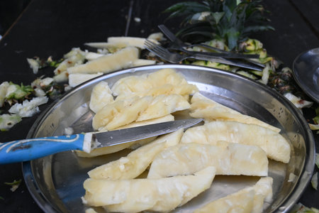 Pineapple or Ananas comosus chopping with knife. It is aÂ tropical plantÂ with an edible fruit. It is plant in the familyÂ Bromeliaceae. Fruits cutting.の写真素材