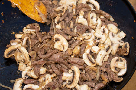 Closeup image of stirfry being cooked on a camping gas cookerの写真素材