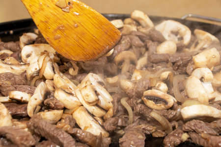 Closeup image of stirfry being cooked on a camping gas cookerの写真素材
