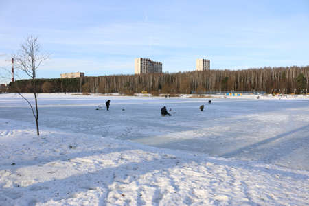 fishermen on the lake in winterの写真素材