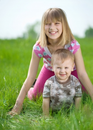 Happy Kids-sister and brother having fun outdoorの写真素材