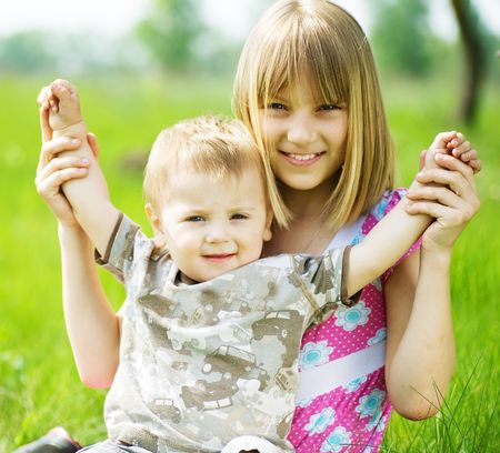 Happy Kids-sister and brother having fun outdoorの写真素材