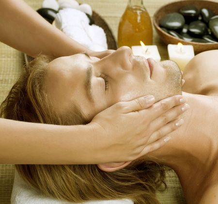 Spa.Young Man getting Face Massage.の写真素材