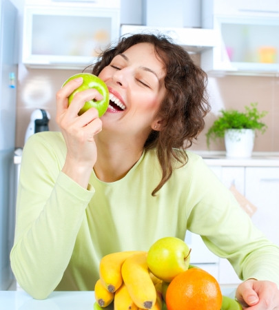 Dieting concept  Healthy Food  Young Woman Eats Fresh Fruit の写真素材