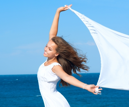 Girl With White Scarf on The Beach  Travel and Vacationの写真素材