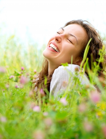 Beautiful Young Woman lying in Meadow of Flowers  Enjoy Natureの写真素材