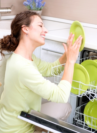 Dishwasher  Young woman in the Kitchen doing Housework  Wash-upの写真素材