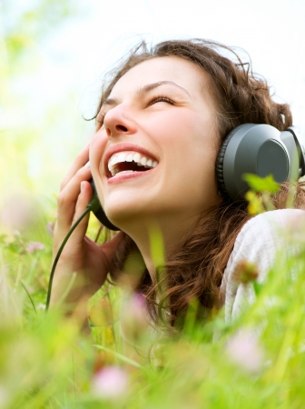 Beautiful Young Woman with Headphones Outdoors  Enjoy Music の写真素材