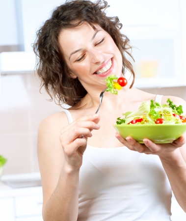 Diet  Beautiful Young Woman Eating Vegetable Saladの写真素材