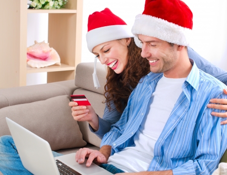 Young couple with laptop and credit card buying online の写真素材