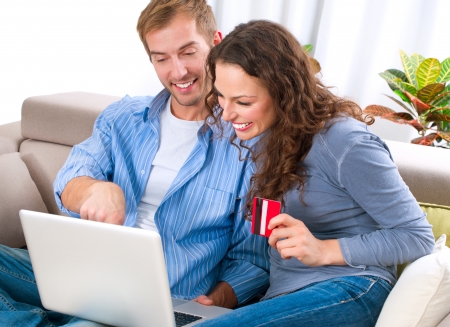 Young couple with Laptop and Credit Card buying onlineの写真素材