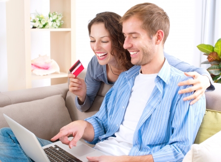 Young couple with Laptop and Credit Card buying onlineの写真素材