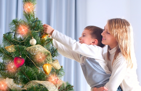 Kids Decorating Christmas Tree  Happy Childrenの写真素材