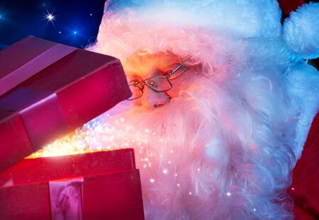 Santa Claus with Magic Christmas Gift の写真素材