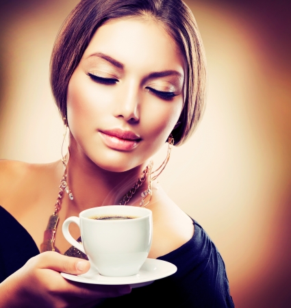 Beautiful Girl Drinking Tea or Coffee  Sepia Tonedの写真素材