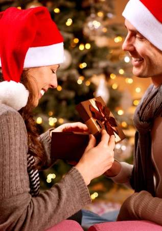 Christmas Scene  Happy Couple with Christmas Gift at Home の写真素材