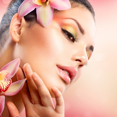Beautiful Spa Girl With Orchid Flowers Touching her Face の写真素材