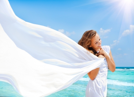 Beautiful Girl With White Scarf on The Beach の写真素材
