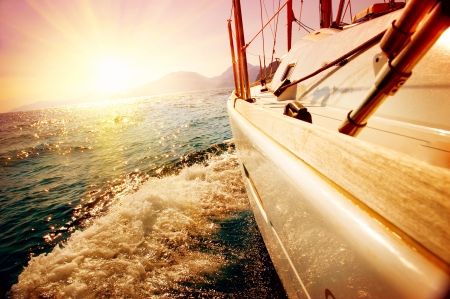 Yacht Sailing against sunset  Sailboat  Yachting  Sailingの写真素材