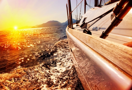 Yacht Sailing against sunset  Sailboat  Yachting  Sailingの写真素材