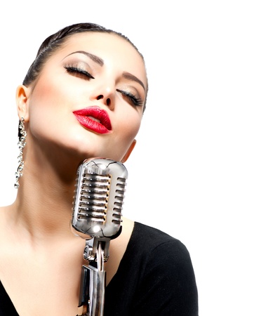 Singing Woman with Retro Microphone isolated on whiteの写真素材