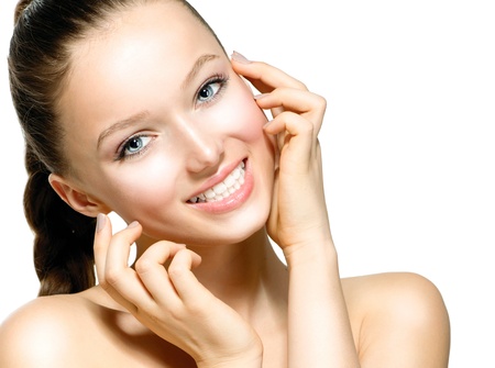 Beautiful Young Woman with Fresh Clean Skin touching her Face の写真素材