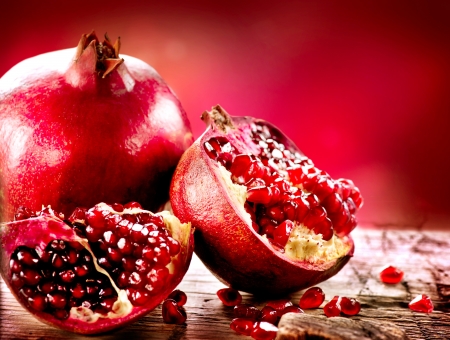 Pomegranates over Red Background Organic Bio fruits Pomegranates over Red Background Organic Bio fruits