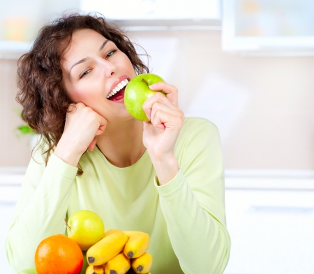 Dieting concept  Healthy Food  Young Woman Eats Fresh Fruit の写真素材