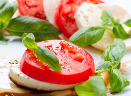 Caprese Salad  Tomato and Mozzarella slices with basil leaves の写真素材