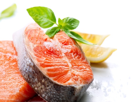 Raw Salmon Red Fish Steak with Herbs and Lemon isolated on White の写真素材