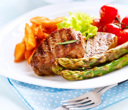Grilled Beef Steak Meat with Fried Potato, Asparagus, Tomatoes の写真素材