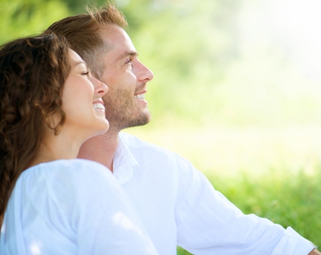 Happy Smiling Couple Relaxing in a Park の写真素材