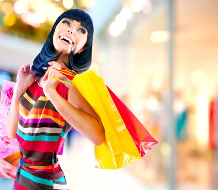 Beauty Woman with Shopping Bags in Shopping Mall