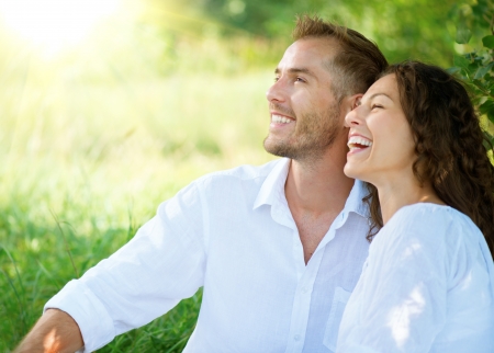Happy Smiling Couple Relaxing in a Park の写真素材