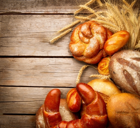 Bakery Bread and Sheaf over Wood Backgroundの写真素材