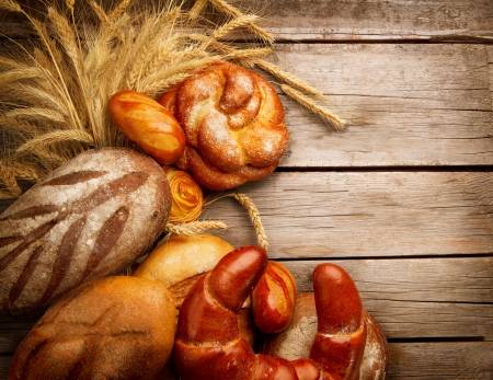 Bakery Bread and Sheaf over Wood Backgroundの写真素材