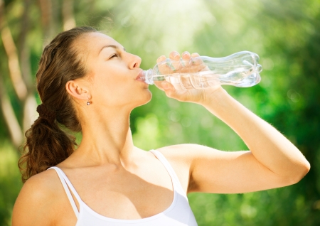 Healthy and Sporty Young Woman Drinking Water from the bottleの写真素材