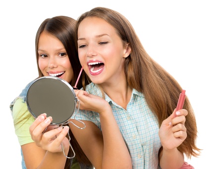 Pretty Teenage Girls Applying Make up and Looking in the Mirror の写真素材