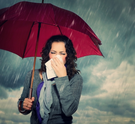 Sneezing Woman with Umbrella の写真素材